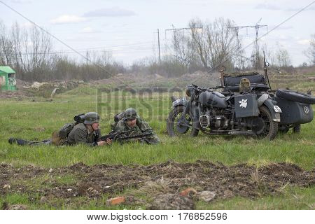 SAINT PETERSBURG, RUSSIA - MAY 05, 2015: Lying German motorcyclists. Reconstruction of the episode of the great Patriotic war