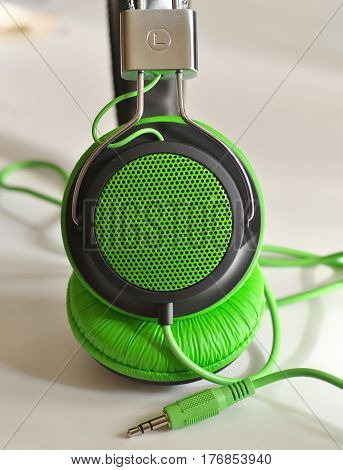 stylish green Music soft closeup headphones whith plug