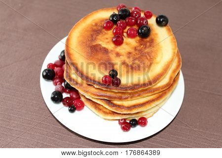 A pancake is a flat cake often thin and round prepared from a starch-based batter that may also contain eggs milk and butter and cooked on a hot surface such as a griddle or frying pan often with oil or butter. They may be served at any time with a variet