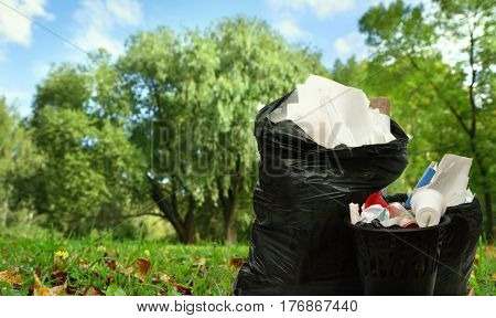 Full Black Wastebasket And Plastic Bags