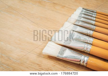 Retro Paintbrushes On Wooden Table Background With Space For Text