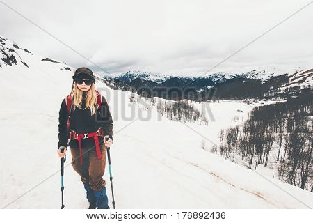 Woman climbing at snowy foggy mountains Travel Lifestyle concept adventure active vacations outdoor mountaineering sport wanderlust hiking wild nature