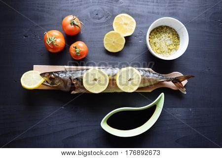 Smoked fish with lemon, on  wooden board,  Mackerel