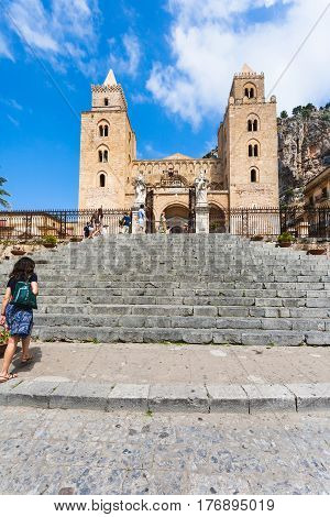 People Near Gate In Duomo Di Cefalu In Sicily