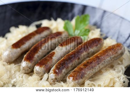nuremberg bratwurst on cabbage in a pan