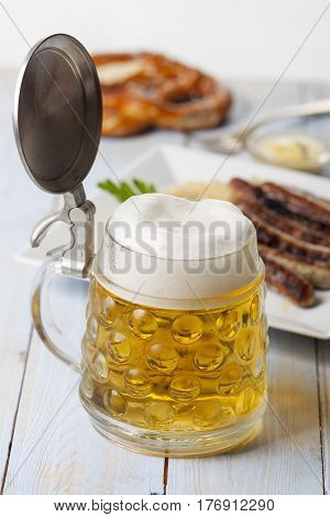 beer in a mug and nuremberg bratwurst