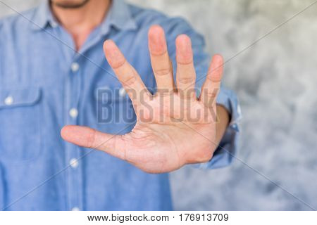 a Young man is showing palm handsign.