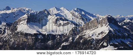 Snow covered mountains Schwalmis and Brisen. View from mount Fronalpstock Stoos.