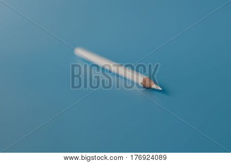 white pancil isolated on a blue background