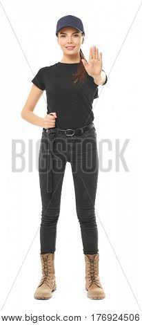 Beautiful young woman in security uniform on white background