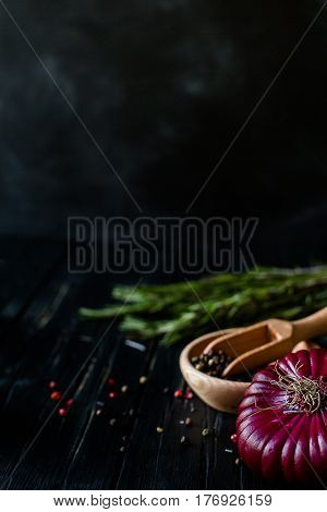 Red onions on a blue wooden table, close up. vertical .place for text