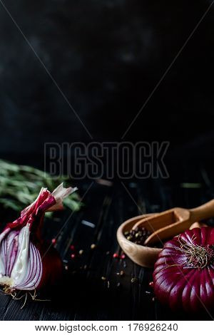 Red onions on a blue wooden table, close up. vertical .place for text