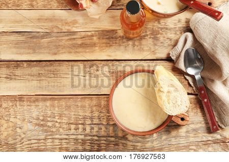 Delicious cream soup with bread on table