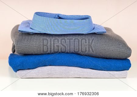 stack of clothing isolated on white sweaters Shirts knitwear space for text
