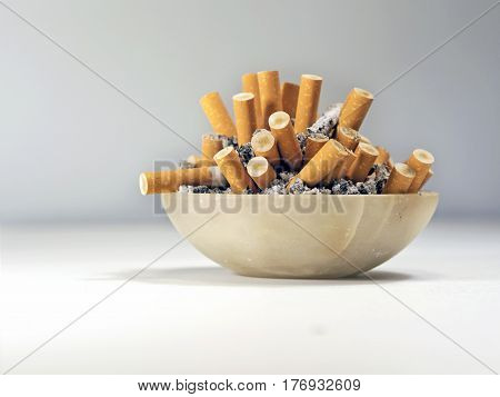 the habit of smoking cigarettes and fill ashtray