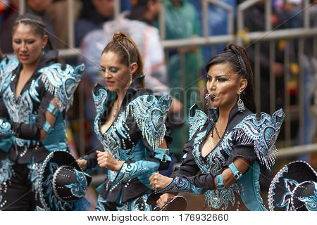 ORURO, BOLIVIA - FEBRUARY 25, 2017: Caporales dancers in ornate costumes performing as they parade through the mining city of Oruro on the Altiplano of Bolivia during the annual carnival.