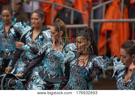 ORURO, BOLIVIA - FEBRUARY 25, 2017: Caporales dancers in ornate costumes performing as they parade through the mining city of Oruro on the Altiplano of Bolivia during the annual carnival.