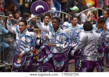 ORURO, BOLIVIA - FEBRUARY 25, 2017: Caporales dancers in ornate costumes performing as they parade through the mining city of Oruro on the Altiplano of Bolivia during the annual carnival.