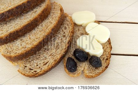 Bran bread and besides black olives, cheese, the most beautiful breakfast cheese and black olives.In different concepts bread, olive and cheese pictures,