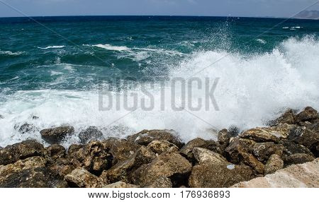 Big wave the azure sea is divided into bryzkami on the rocky shore