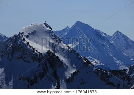 Summit cross on mount Rophaien Swiss Alps. View from mount Fronalpstock Stoos.