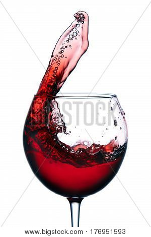 Glass with a splash of red wine isolated on white background. Clarity wineglass and wine. Aesthetics and delight. Relaxation. Luxury.
