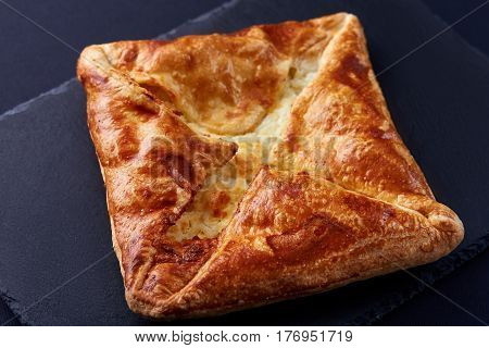 Homemade cheese puff pastries on black background. Cooking and baker. Tasty and appetizing. Delicious food. Your breakfest or dinner.