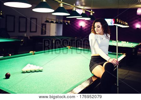 Young Curly Girl Posed Near Billiard Table. Sexy Model At Black Mini Mini Skirt Play Russian Snooker