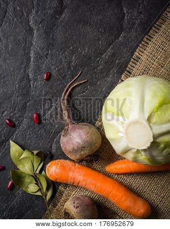 Beets, Carrots And Cabbage During Cooking. Composition On A Dark Background.