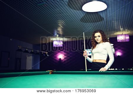 Young Curly Girl Posed Near Billiard Table. Sexy Model At Black Mini Mini Skirt Play Russian Snooker