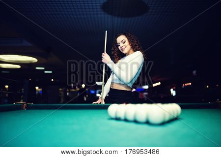 Young Curly Girl Posed Near Billiard Table. Sexy Model At Black Mini Mini Skirt Play Russian Snooker