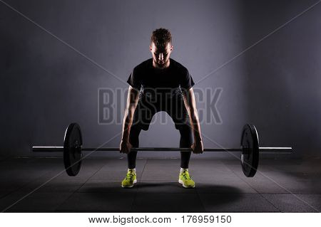 Crossfit fitness gym heavy weight lifting bar by strong man workout