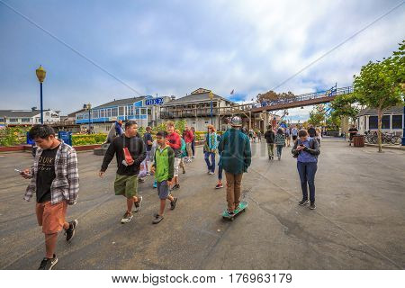 San Francisco, California, United States - August 14, 2016: people and tourists at Fisherman's Wharf district at Pier 39 along the Embarcadero in San Francisco. Leisure, holidays and travel concept.
