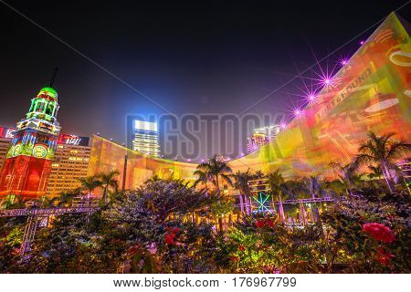 Hong Kong, China - December 5, 2016: 3D light show of Hong Kong Cultural Centre and Clock Tower, popular symbol of Hong Kong city. Victoria Harbour waterfront, Tsim Sha Tsui. Night scene.
