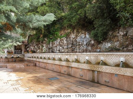 Old venetian fountain with lion heads springs pure drinking water in Spili Crete Greece
