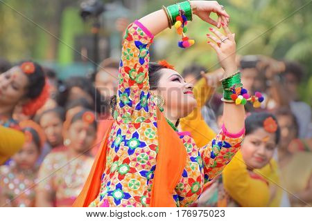KOLKATA INDIA - MARCH 12 2017: Young girl dancers joyful dance at Holi/Spring festivalknown as Dol (in Bengali) or Holi (in Hindi) celebrating arrival of Spring in India. Popular Indian festival.