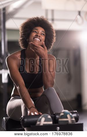 young fit african american woman doing sit ups in fitness studio at the gym.Abdominal exercises Sit up