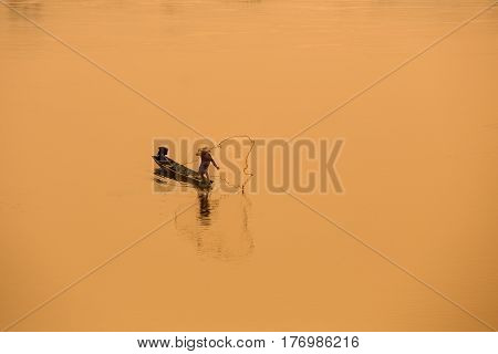 Fisherman on the boat are catching fish in Mekong river Thai - Laos