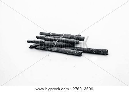 Close Up Of Bidi Or Thin Cigar Or Small Cigarette Isolated On White.