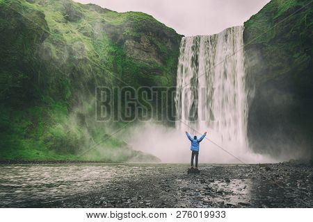 Single Man Standing Near Scogafoss Waterfall In Iceland And Spread His Hands. Travel Summer Nordic C