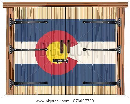 A Large Closed Wooden Barn Double Door With Bolt And Hinges And The Colorado Flag Painted On
