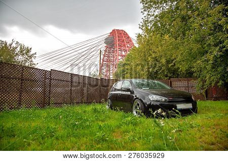 Moscow. Summer 2018. Black Tuned Volkswagen Golf With Chrome Wide Wheels Against The Backdrop Of A P