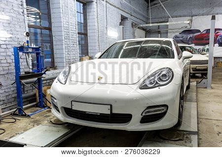 Moscow. November 2018. White Porsche Panamera At The Wheel Alignment Stand Of The Service Center. Sp
