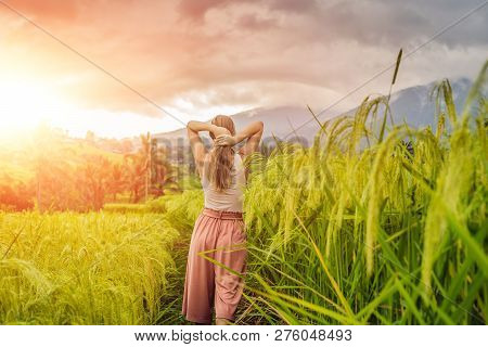 Young Woman Traveler On Beautiful Jatiluwih Rice Terraces Against The Background Of Famous Volcanoes