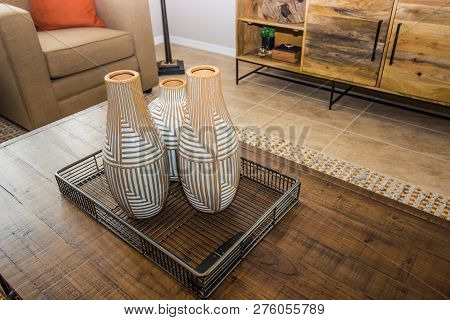 Three Vases In Tray On Wood Grain Coffee Table