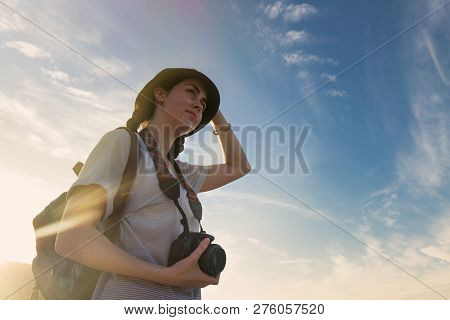 Girl With A Camera On A Blue Sea Background.