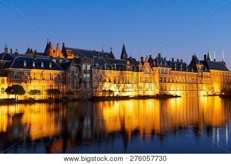 View Of Binnenhof - Dutch Parliament At Night Over Hofvijver Pond Illuminated At Night, Hague Hollan
