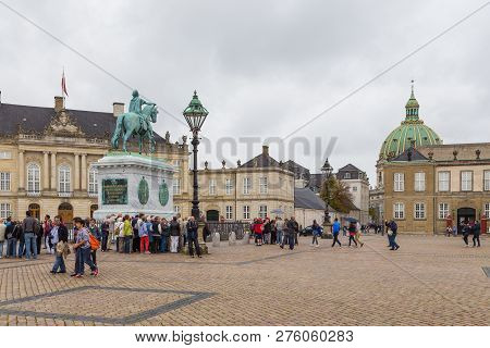 Copenhagen, Denmark- 30 August 2014: Amalienborg, Riding Statue Of King Frederick V. In The Backgrou