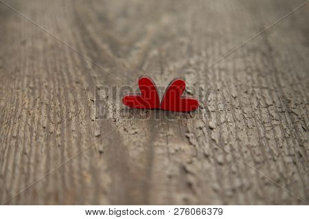 Two Wooden Red Hearts On An Old Dry Wooden Board For Valentines Day Close-up.