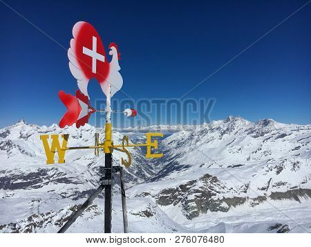 Wind Vane (weathercock) On Top Of Klein Matterhorn In Front Matter Valley And Alpine Landscape With 